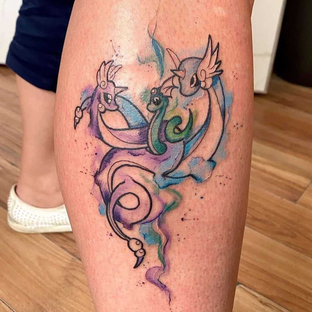 Colorful abstract dragon tattoo on a woman's calf