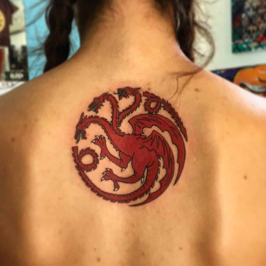 Back tattoo of the Targaryen sigil from Game of Thrones, featuring a bold red three-headed dragon in a circular emblem