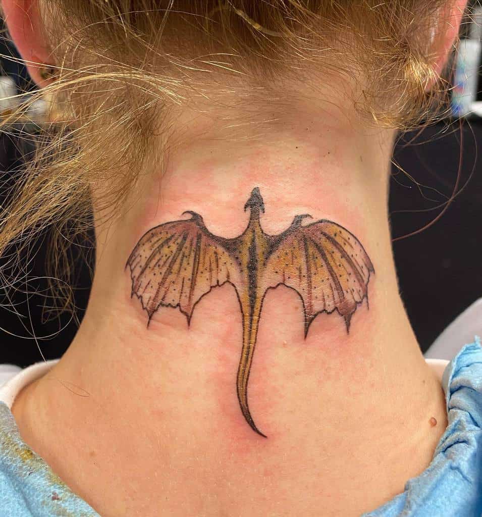 A dragon tattoo on the back of a person's neck, with wings spread wide
