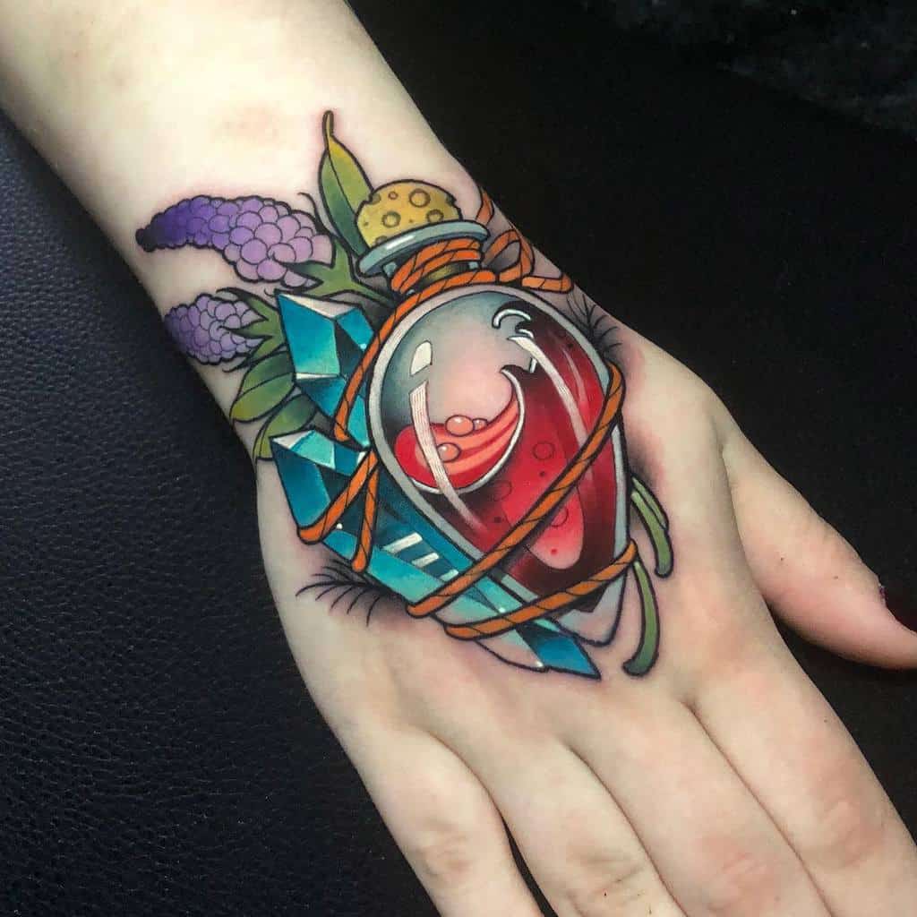 A vibrant tattoo featuring a potion bottle with red liquid, wrapped in rope, surrounded by crystals, flowers, and mystical elements