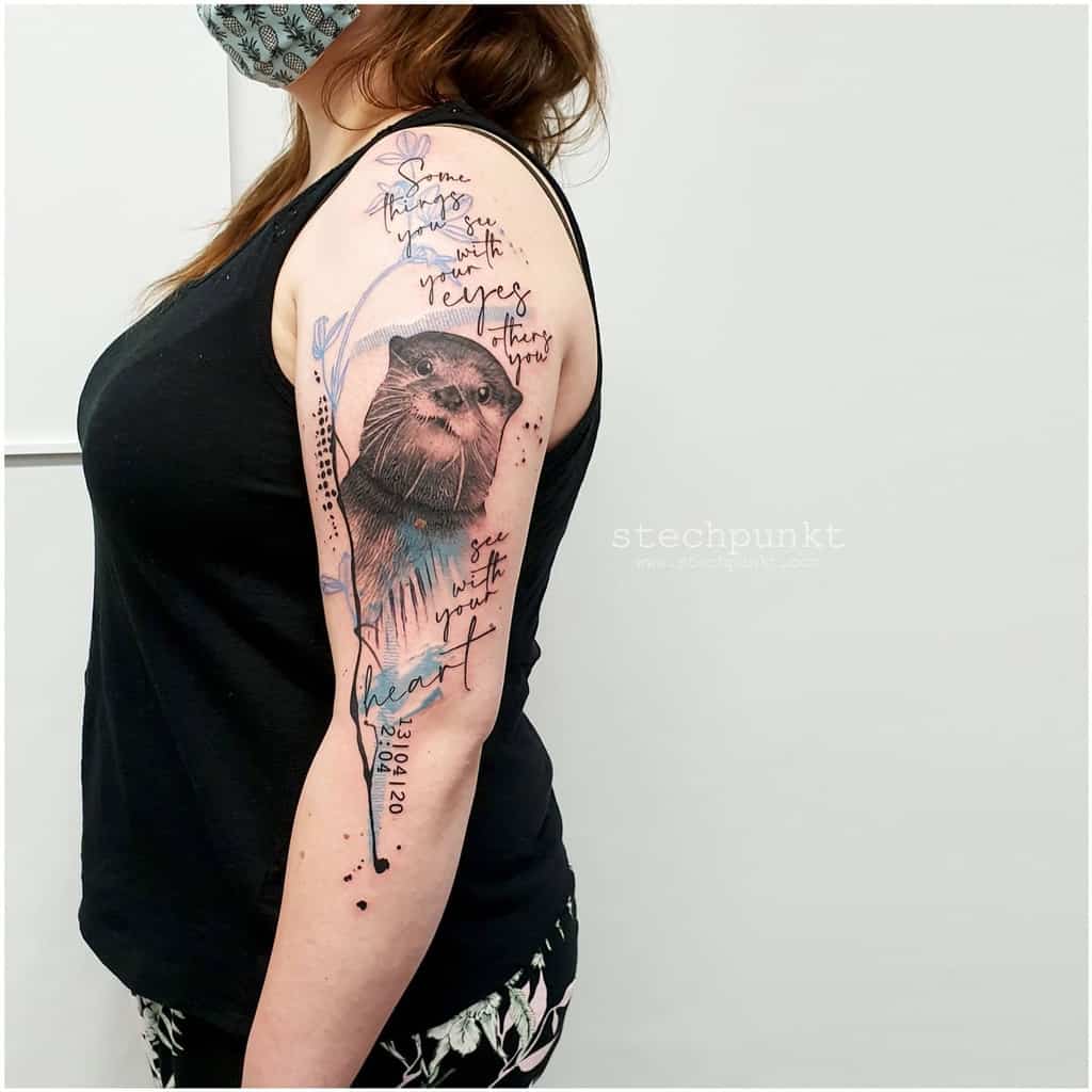 Person with long hair flaunts otter tattoo surrounded by handwritten text and whimsical elements