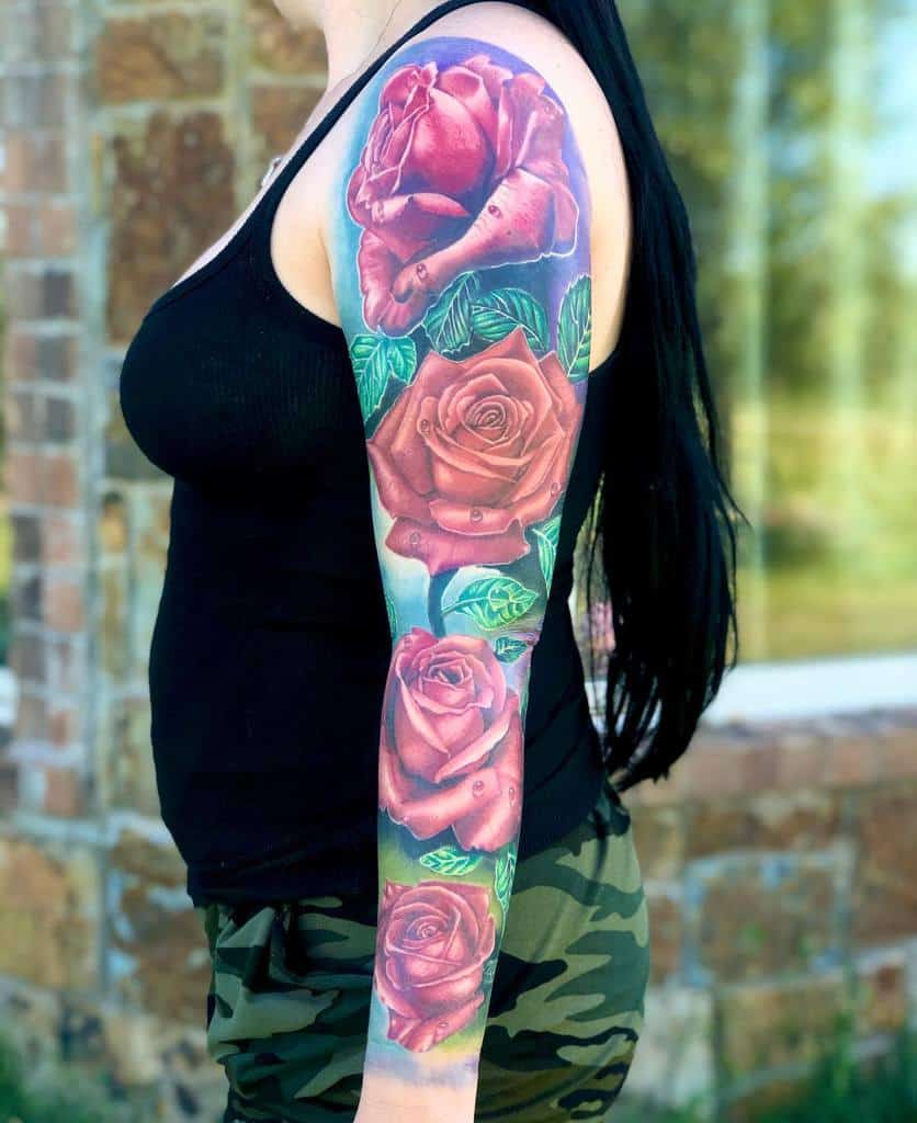 A woman with a colorful sleeve tattoo of roses on her arm