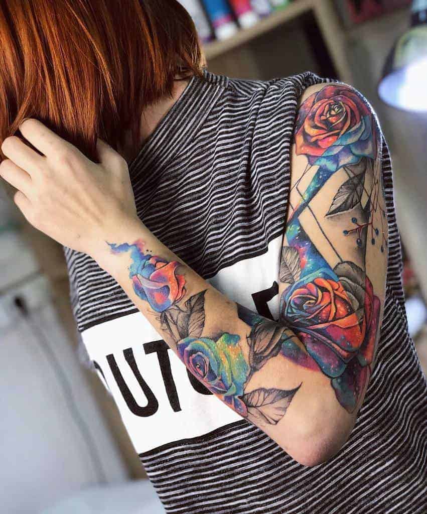 Woeman with colorful rose tattoos on the arm