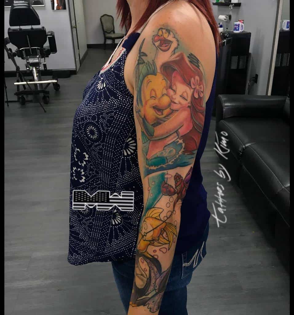 Woman with colorful aquatic-themed sleeve tattoo
