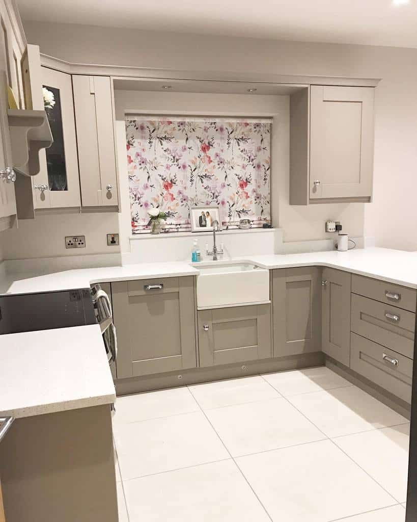 gray kitchen cabinets white countertop apron sink and floor tiles