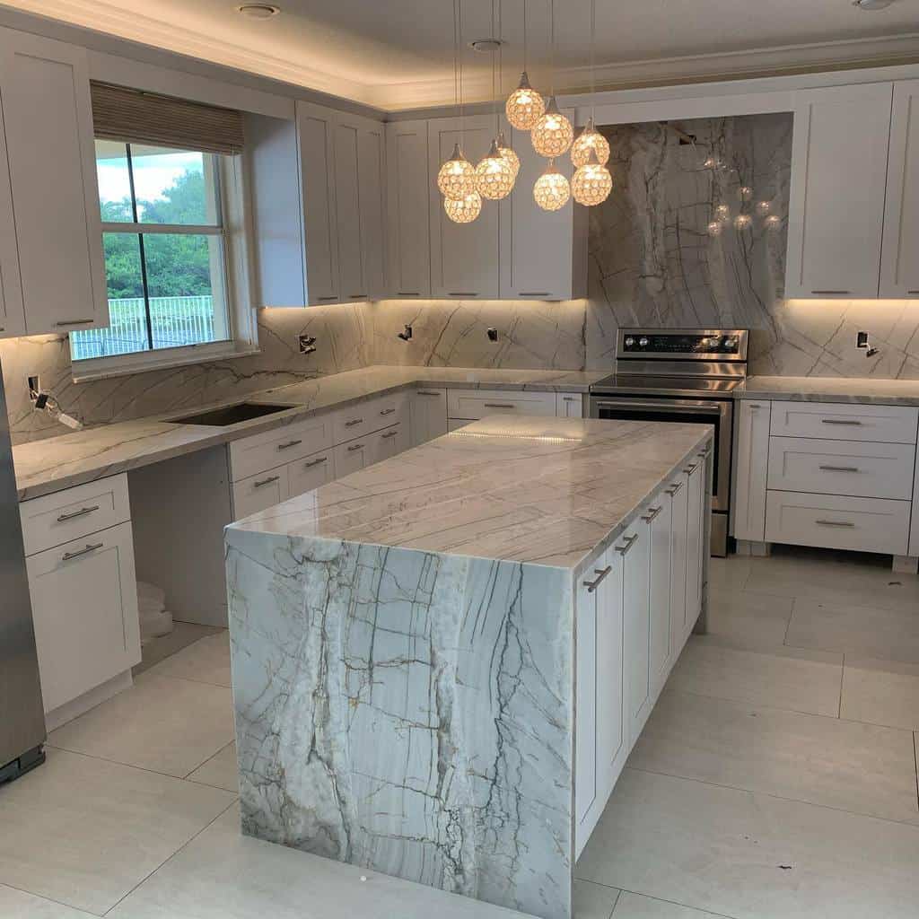 luxury modern kitchen white cabinets gray swirl marble countertops and backsplash pendant lighting
