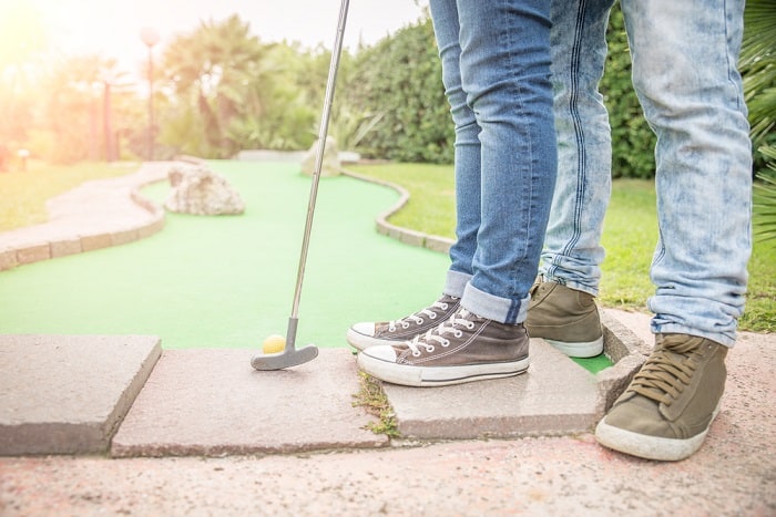 Couple Playing Mini Golf