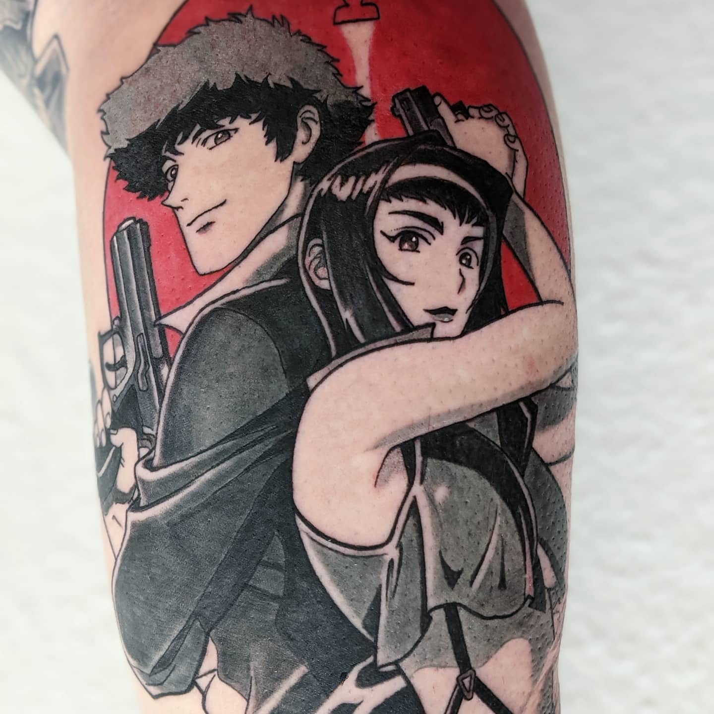 Tattoo of Spike Spiegel and Faye Valentine from Cowboy Bebop, both holding guns back-to-back