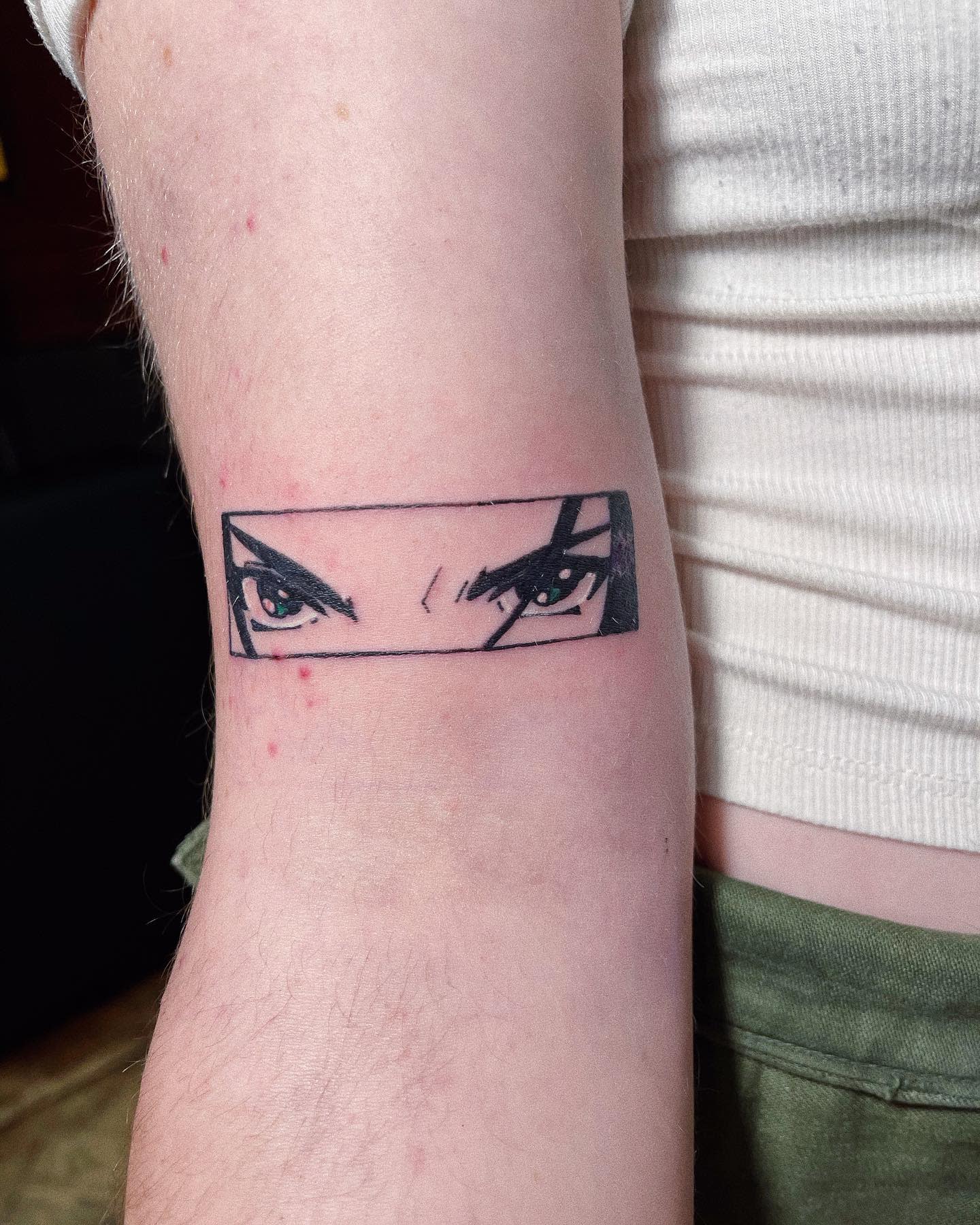 Tattoo of Faye Valentine's intense gaze from Cowboy Bebop, depicted in a rectangular frame on the forearm