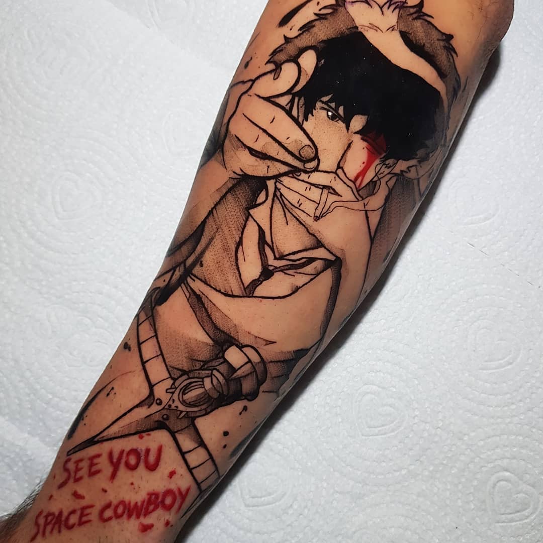 Forearm tattoo of Spike Spiegel from Cowboy Bebop, pointing a finger gun with blood on his face, and the phrase 'See You Space Cowboy' in red