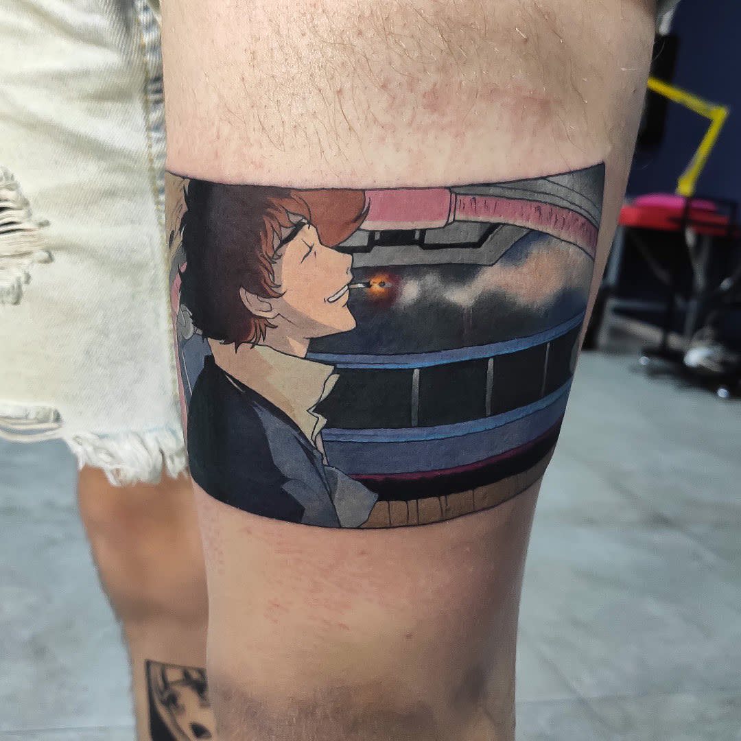 Leg tattoo of Spike Spiegel from Cowboy Bebop, relaxed and smoking a cigarette, with a space background and ship details