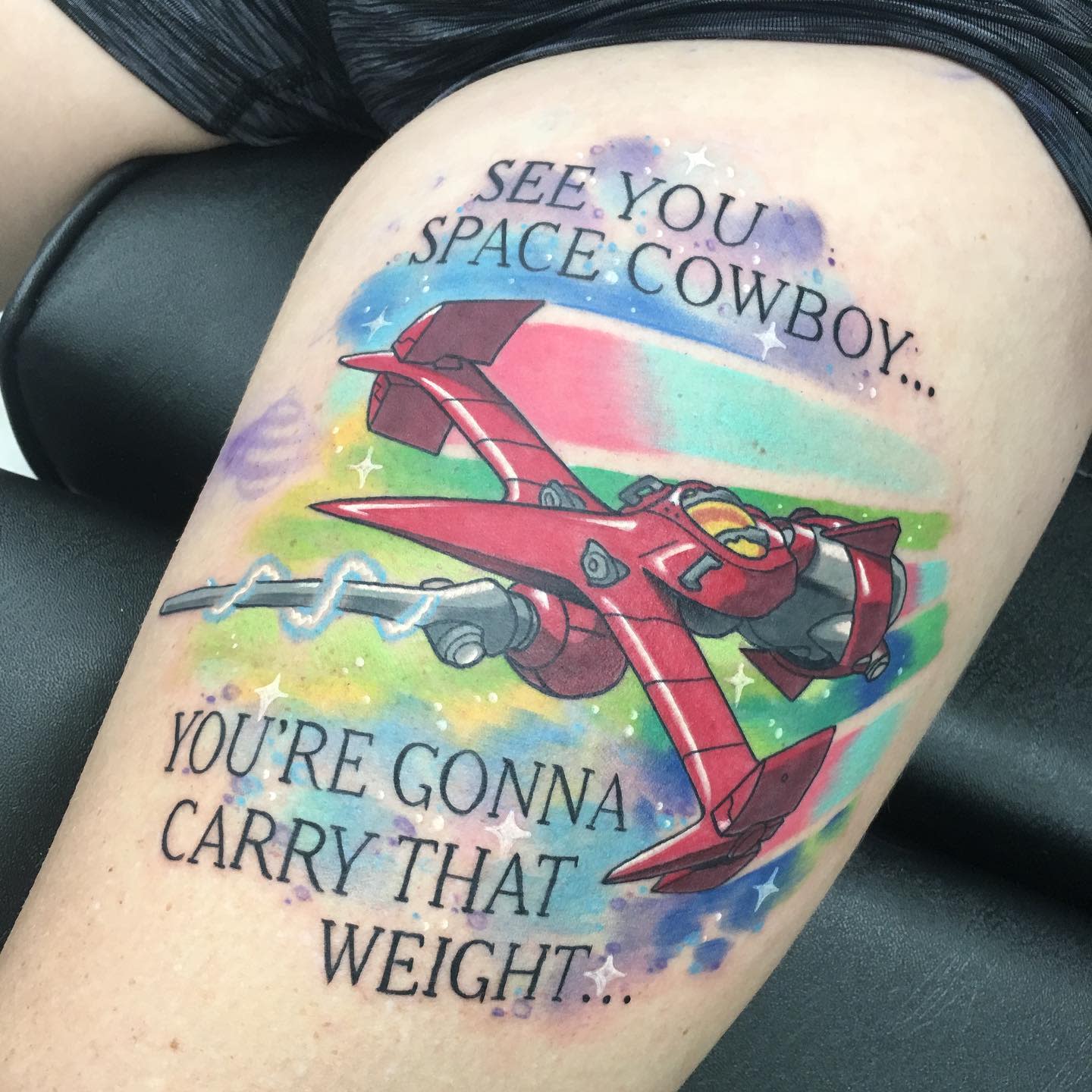 Colorful leg tattoo of the Swordfish II from Cowboy Bebop with the phrases 'See You Space Cowboy...' and 'You're Gonna Carry That Weight...'