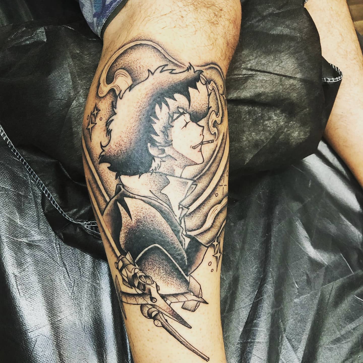 Tattoo of Spike Spiegel from Cowboy Bebop, smoking a cigarette with a relaxed expression