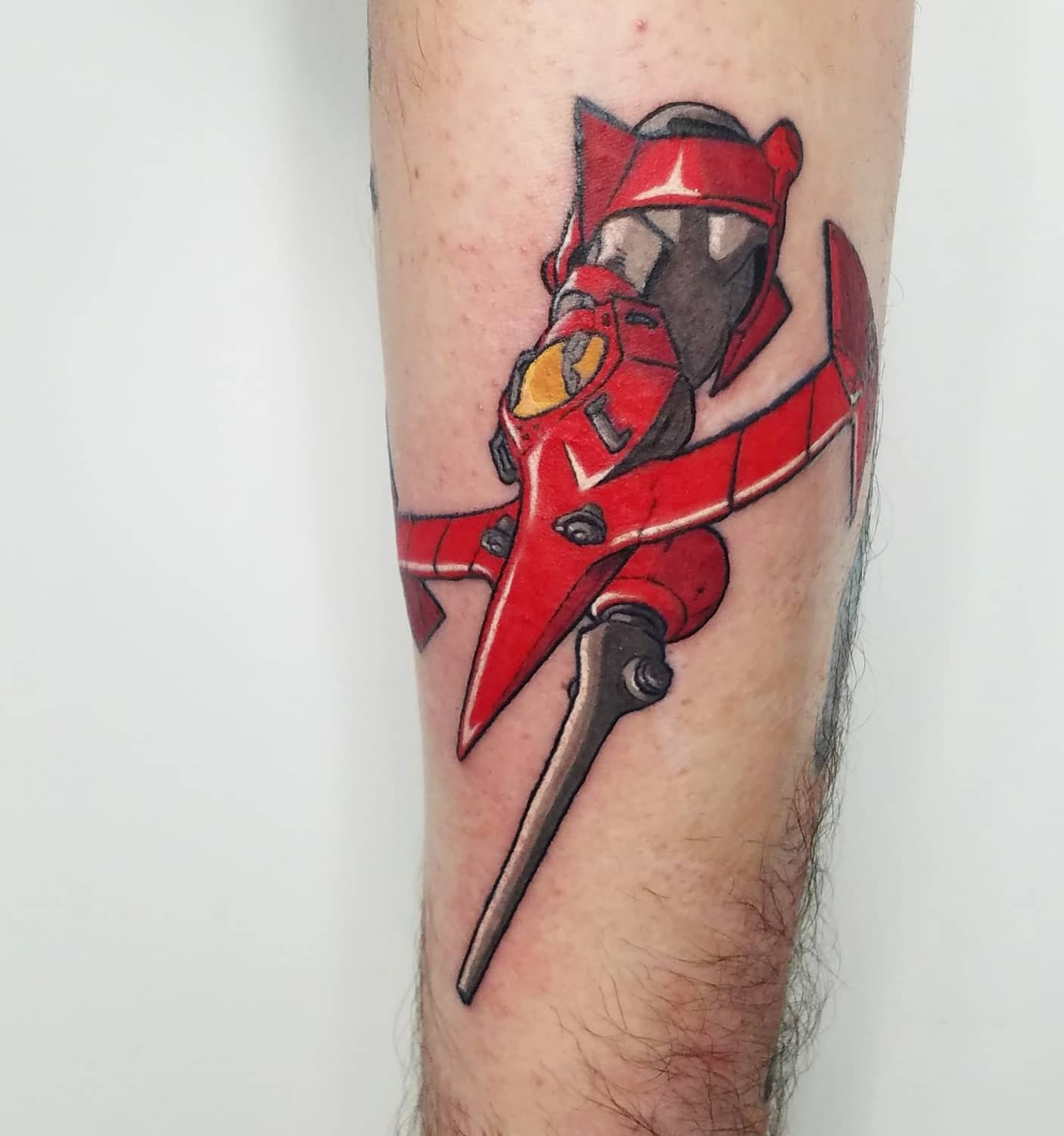 Tattoo of the Swordfish II spaceship from Cowboy Bebop, depicted in vibrant red with detailed shading