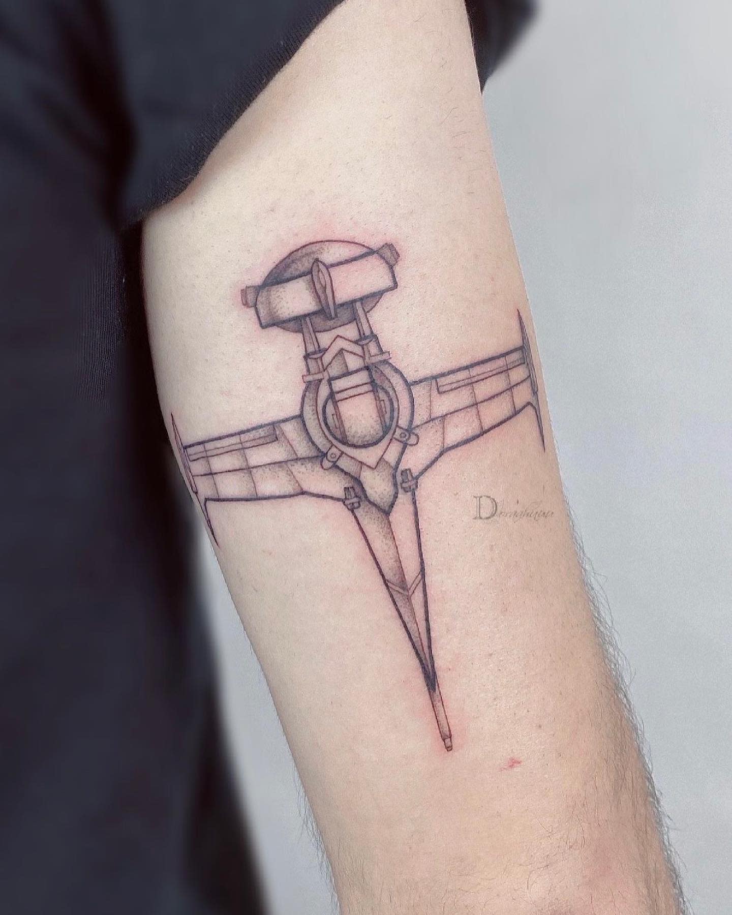 Minimalist tattoo of the Swordfish II spaceship from Cowboy Bebop, outlined in black with subtle shading on the upper arm
