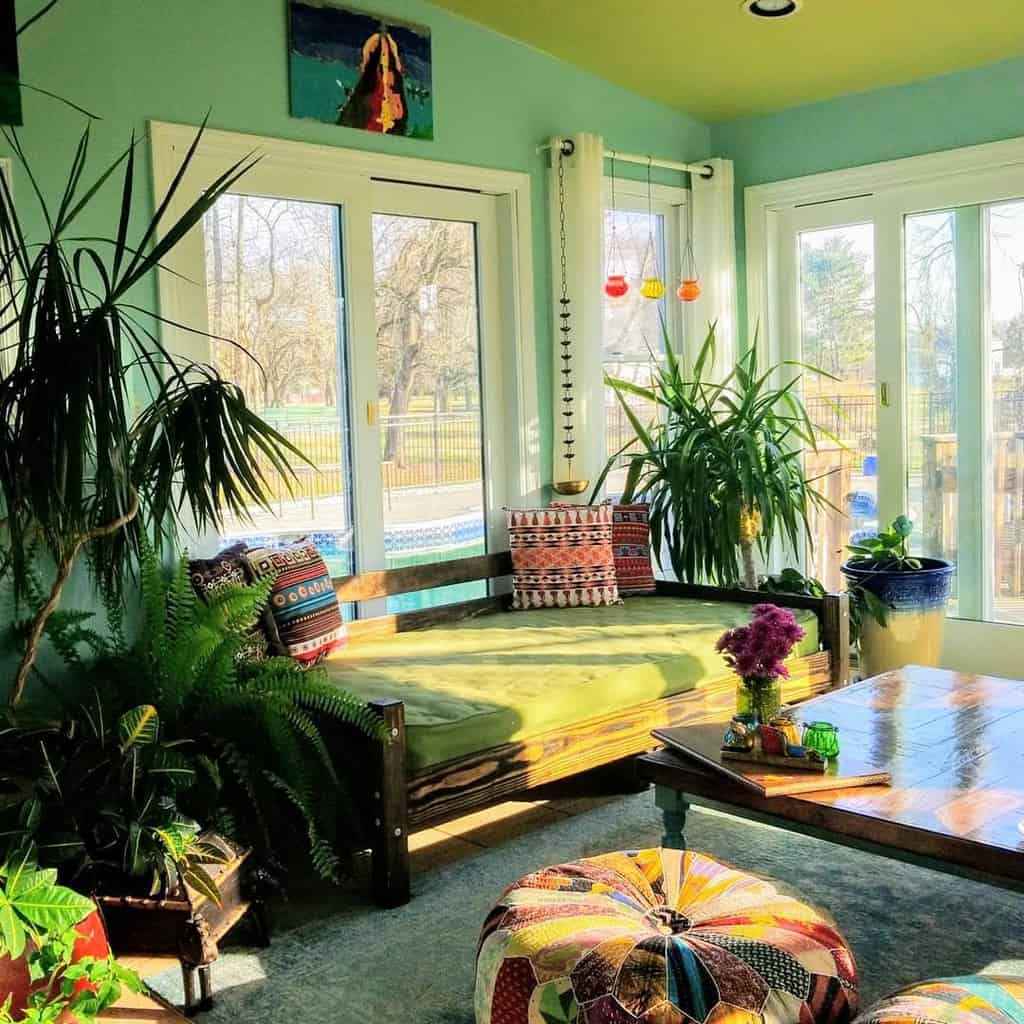 green wall sunroom with wood seating