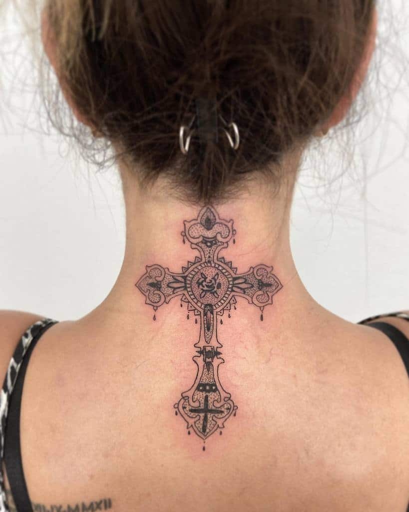 Ornate cross tattoo on the back of neck featuring geometric and intricate designs