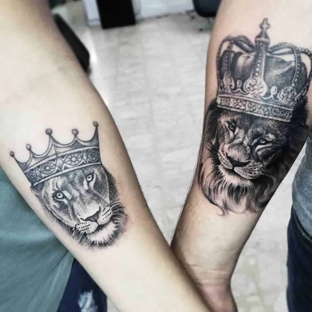 Two crowned lion forearm tattoos touching