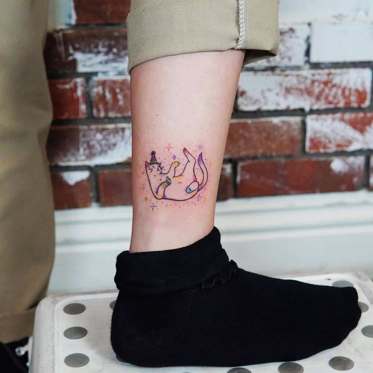 A colorful cat tattoo on the ankle