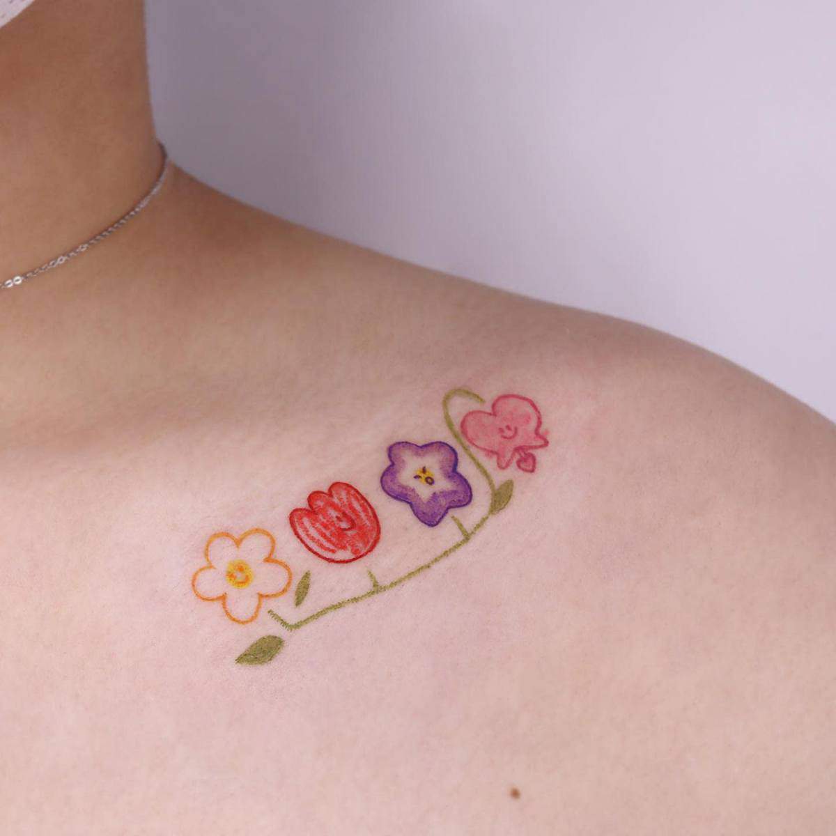 A tattoo of colorful flowers on an upper shoulder
