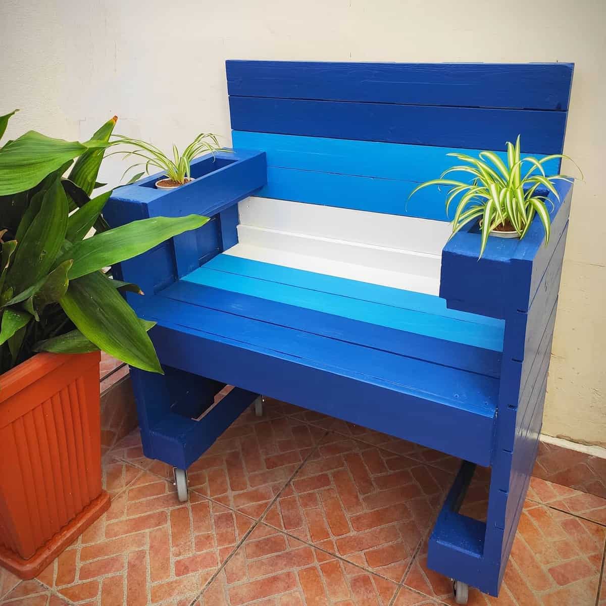 blue painted wood bench on wheels with pot plant holders