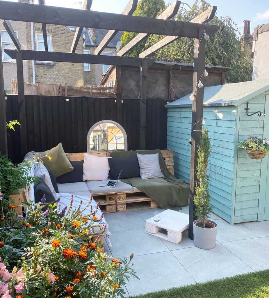 stone slab patio with wood pallet seating wood pergola 