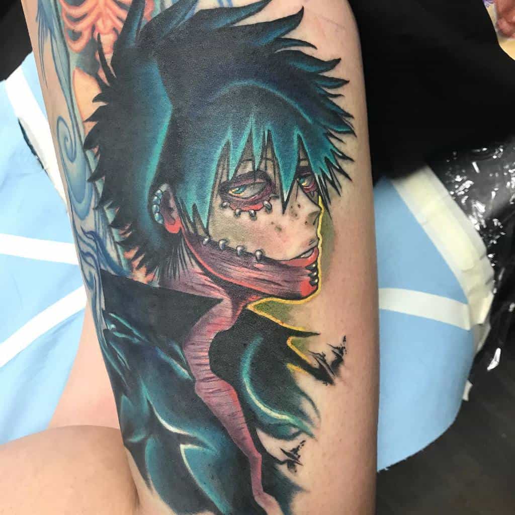 Vibrant tattoo of Dabi from My Hero Academia with glowing blue flames, dark stitches, and intense shading for a dramatic look