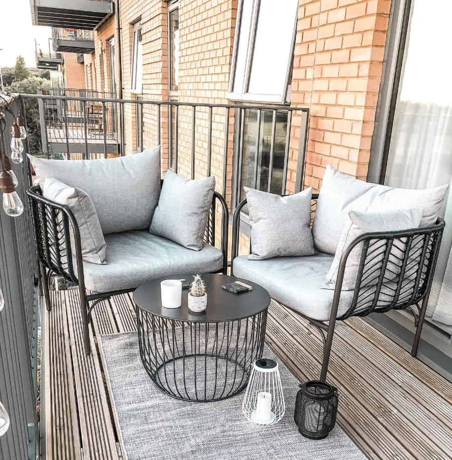 small wood deck balcony patio with metal seats and table 
