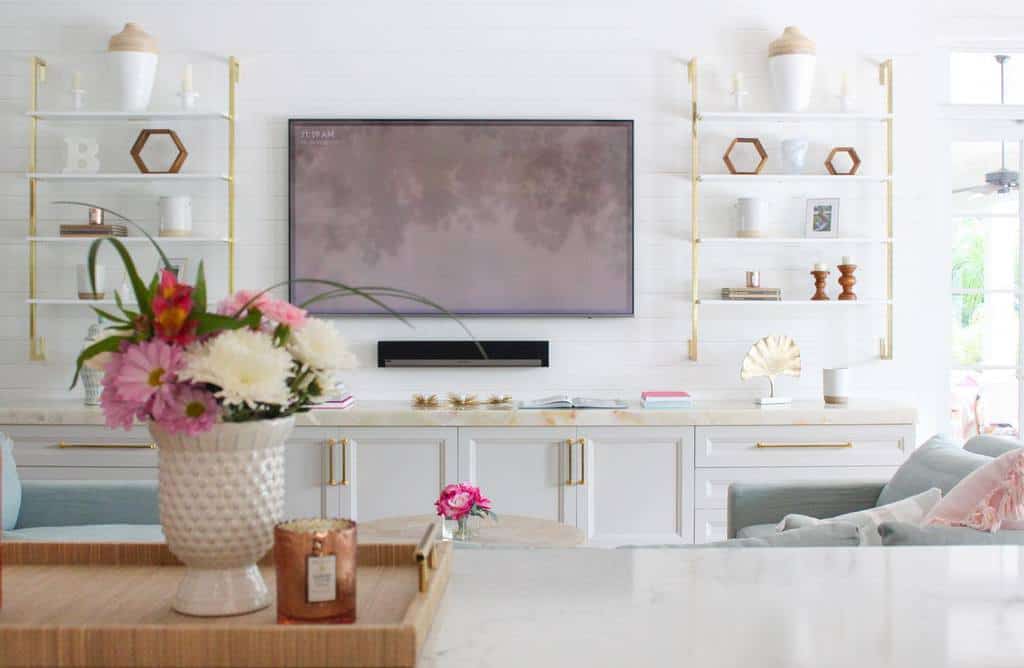 modern living room with white cabinets and gold accents