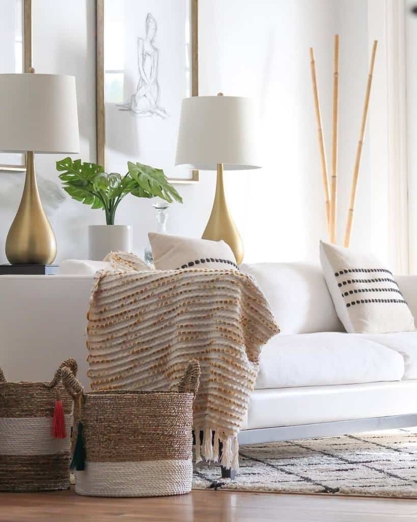 white living room with gold lamps and white sofa