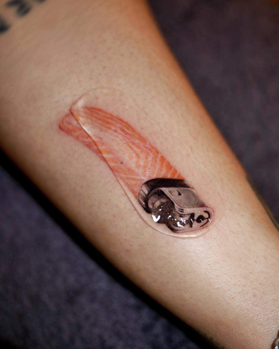 Realistic tattoo of a lighter on an arm