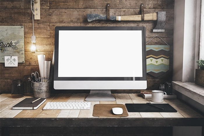 rustic desktop computer workspace wall axe