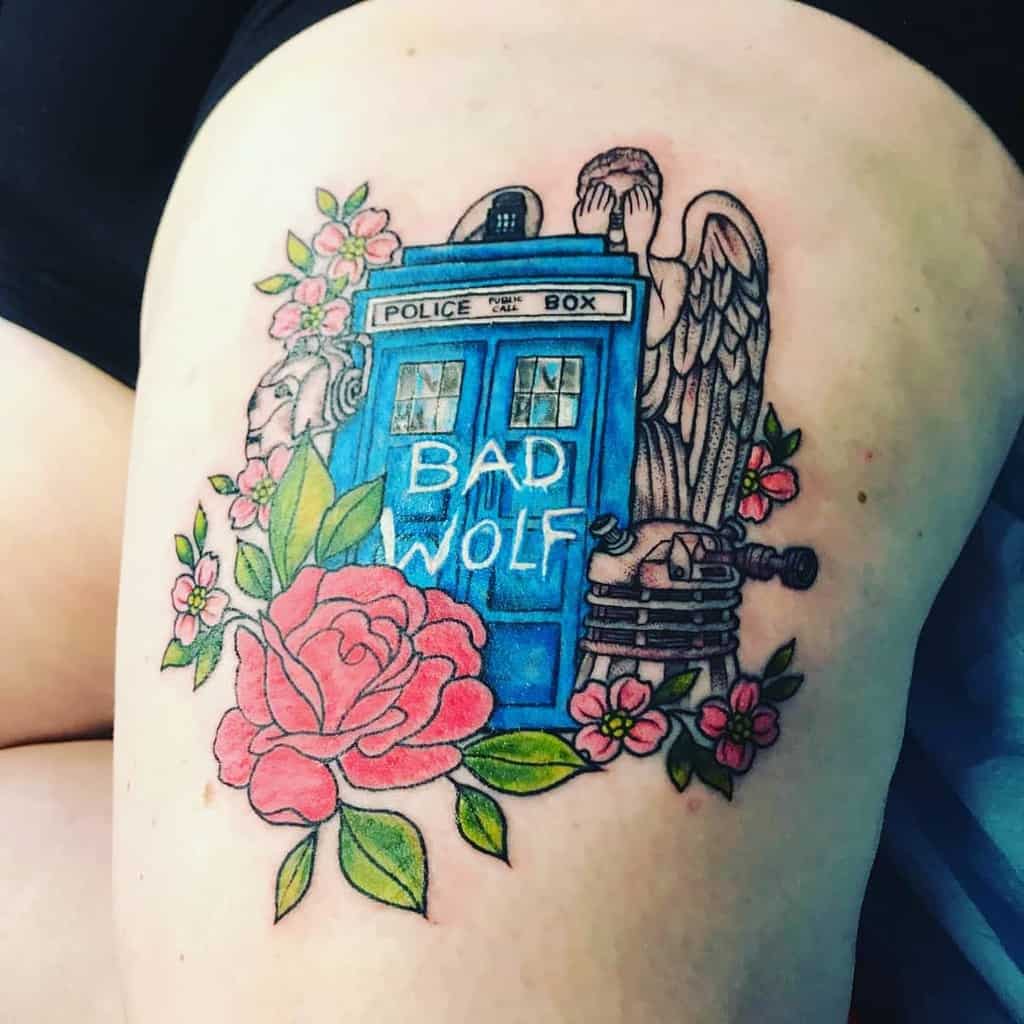 Doctor Who themed tattoo featuring the TARDIS with 'BAD WOLF' text, surrounded by a large red rose, cherry blossoms, and a Weeping Angel