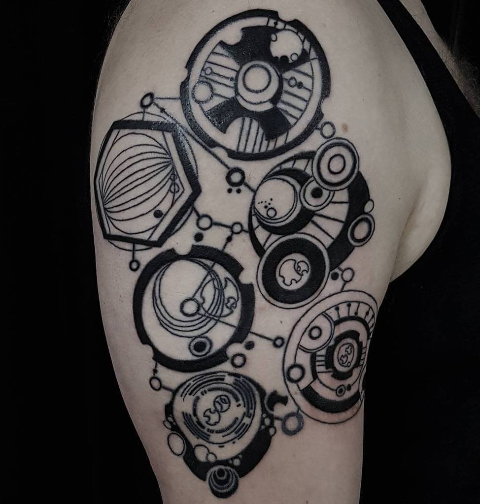 Bold black and white tattoo, featuring intricate Gallifreyan script from 'Doctor Who' with various circular symbols connected by fine lines