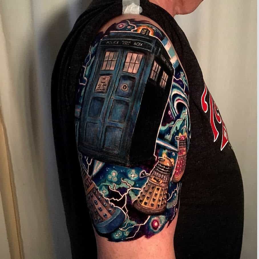 Elaborate Doctor Who tattoo, featuring the TARDIS with vibrant cosmic elements and Daleks, highlighted with electric blue and purple accents