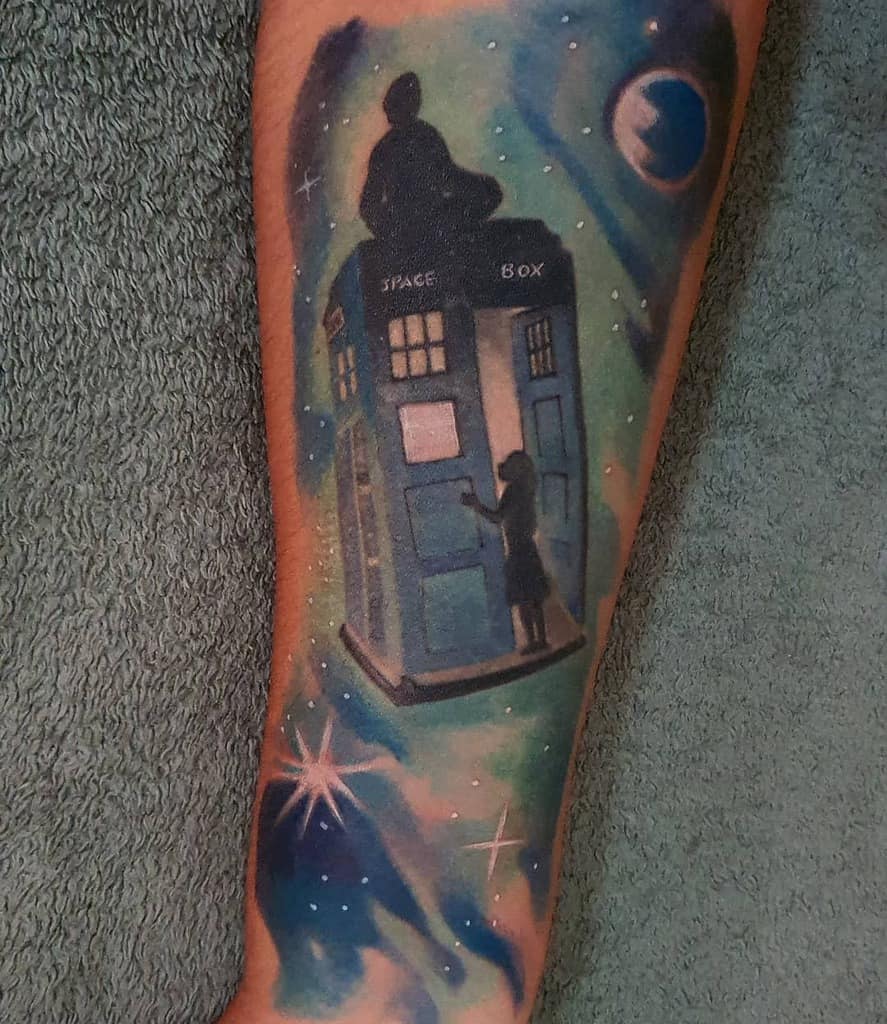 Dreamy Doctor Who tattoo featuring the TARDIS floating in a cosmic scene, with silhouetted figures on top and at the door, surrounded by stars