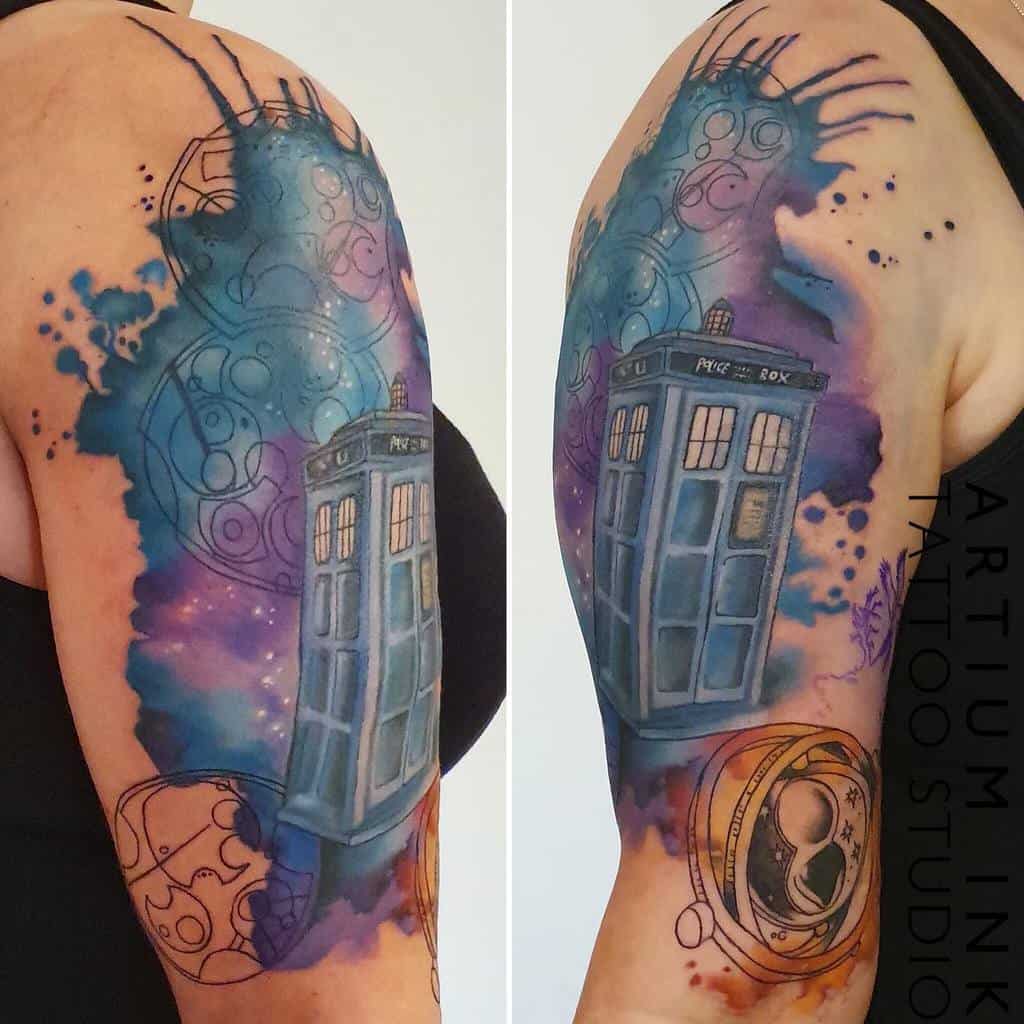 Doctor Who tattoo featuring the TARDIS in a cosmic watercolor design, surrounded by intricate Circular Gallifreyan symbols and a Time Lord pocket watch