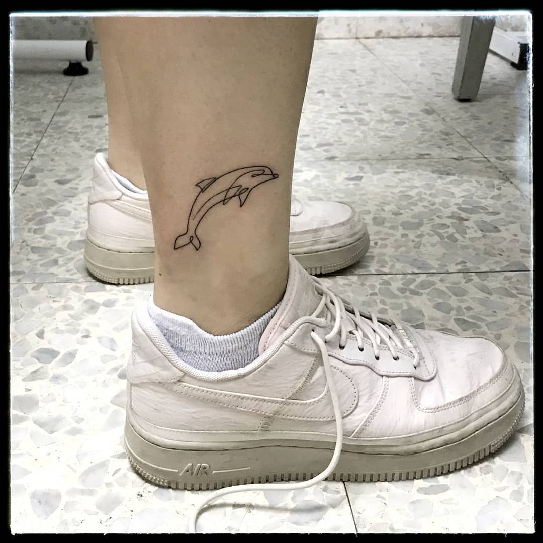 Dolphin tattoo on the ankle