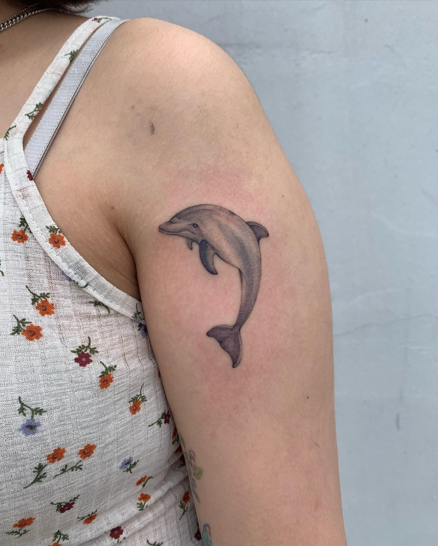 Dolphin tattoo on an upper arm