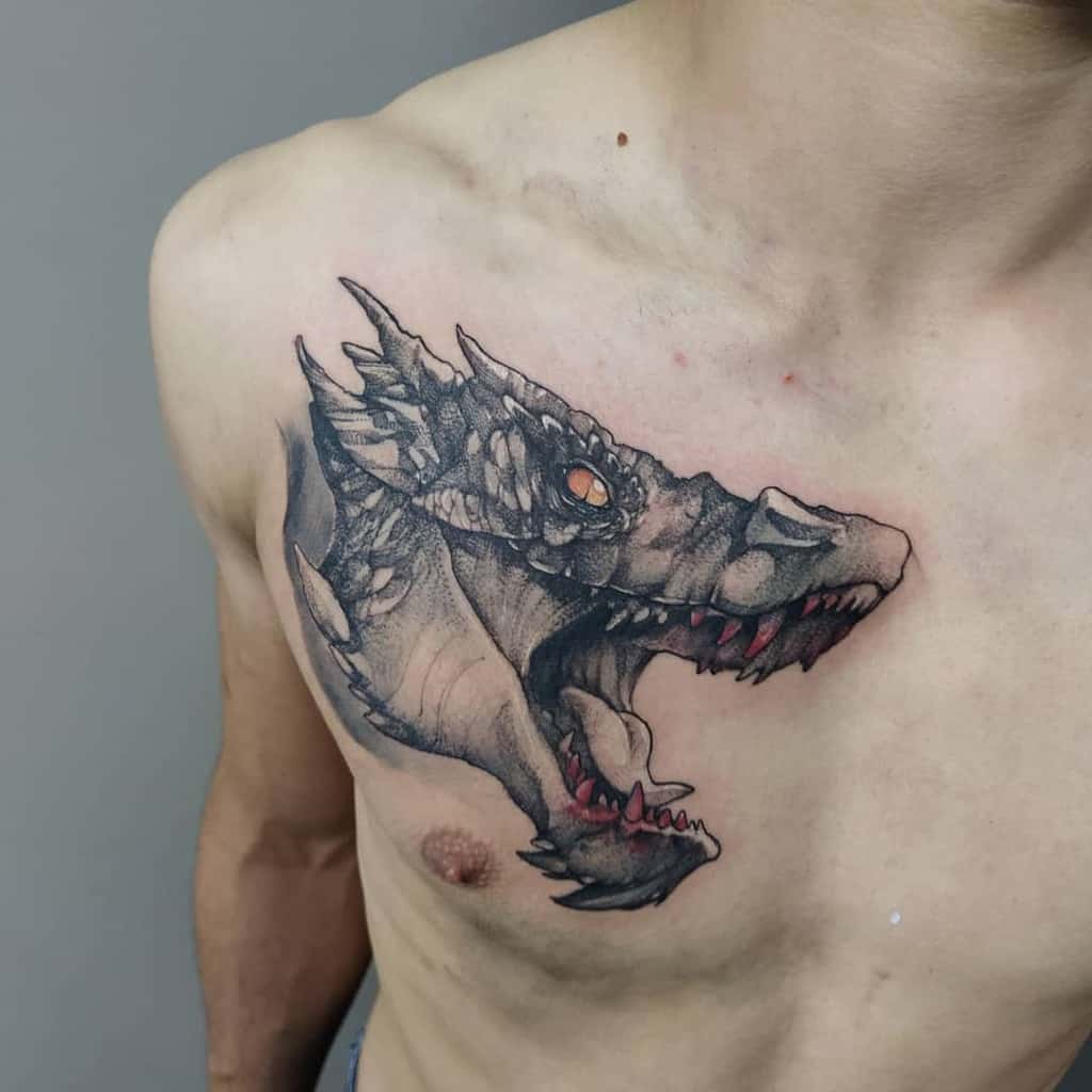 Chest tattoo of a roaring dragon's head with intricately detailed scales and glowing orange eyes