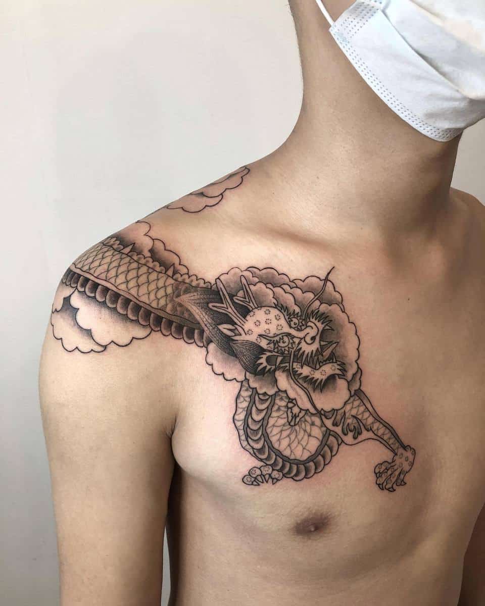 Man with a dragon tattoo on their chest and shoulder