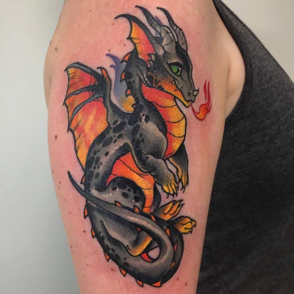 Vibrant upper arm tattoo featuring a small dragon with orange and black scales, detailed wings, and fire-breathing design
