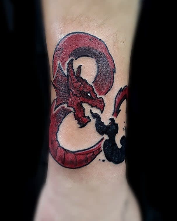 Red dragon breathing fire forming an ampersand symbol, a nod to the Dungeons & Dragons logo