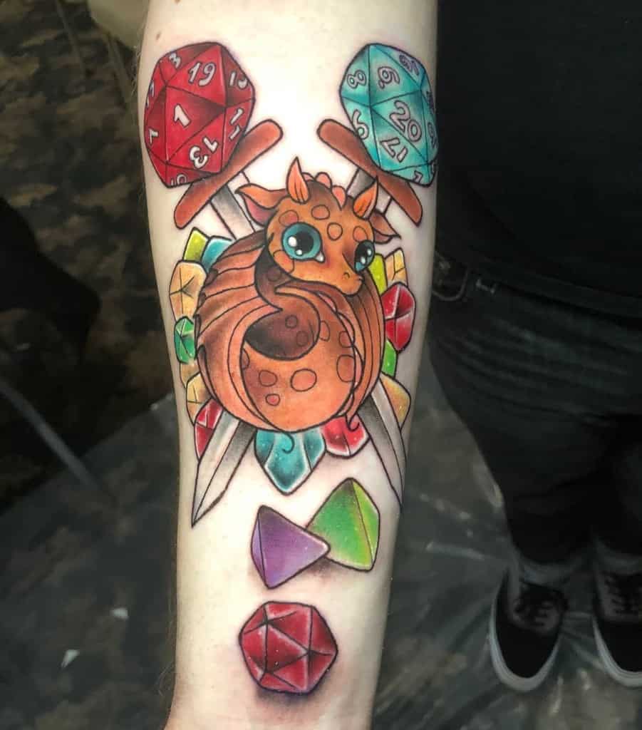 Colorful tattoo of a cute dragon surrounded by D20 dice and vibrant gemstones