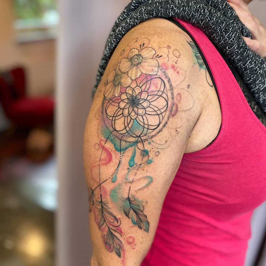 Woman with a colorful dreamcatcher tattoo on her upper arm