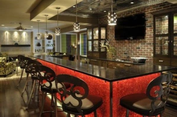 Modern bar interior with red-lit counter, stylish chairs, brick wall, and hanging lights set the perfect scene