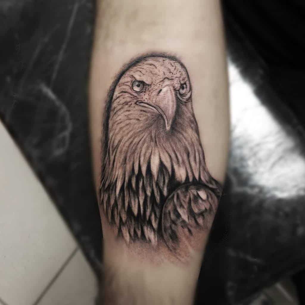 A detailed tattoo of an eagle inked on a forearm