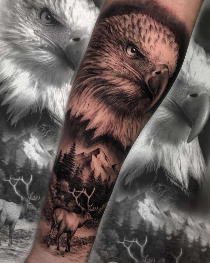 Tattoo of an eagle's head with a forest and deer on an arm