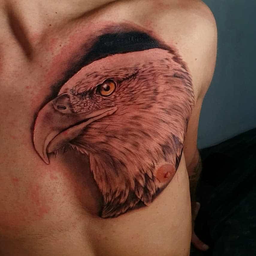 A detailed tattoo of an eagle's head on a chest