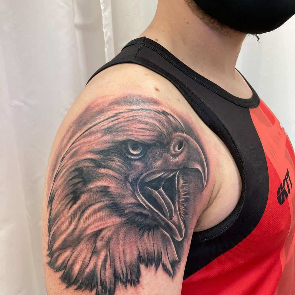 Detailed eagle head tattoo on man's shoulder